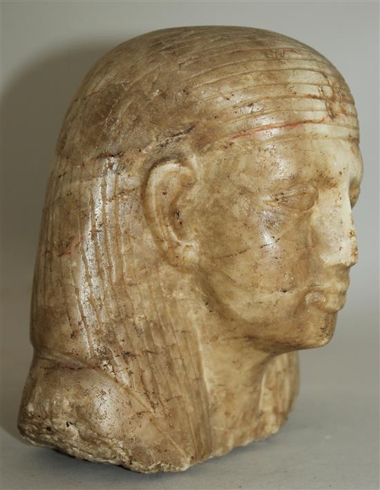 An Egyptian quartzite bust of a man, late period (26th dynasty), possibly a priest, height 17cm